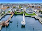 Oversized waterfront property offering landscaped privacy in the front and breathtaking open bay views with spectacular sunsets in the rear. This 60â€™ x 145â€™ lot boasts 115 feet of dock space, providing plenty of room for boating, water sports, and entertaining.This elevated, FEMA-compliant home is built with 2x6 framing and designed for future expansion, with the option to add a second story if desired. The property includes a 3â€“4 car garage with an oversized garage door, tall enough to accommodate an RV, plus a car lift and additional parking for 5â€“6 vehicles.Additionally, there is a spacious 20â€™ x 35â€™ bonus room over the garage that offers panoramic views and endless potentialâ€”perfect for conversion into a primary suite, home office, gym, or artist studio. Additional features include PVC decking, a backyard sun awning, floored attic storage, and an 8â€™ x 20â€™ shed. The bulkhead is in excellent condition, and at low tide, you can enjoy your own sandy beach.This is a rare opportunity to own a versatile waterfront property with privacy, parking, and incredible expansion potential.