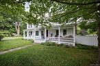 This picturesque four-bedroom, three-bath 1800&rsquo;s farmhouse has been lovingly restored and thoughtfully updated, blending timeless historic farmhouse charm with modern comfort, including fiber-optic internet. Set on 18.5 acres of pure serenity, it offers a storybook setting with two meandering streams, an enchanting spring-fed pond, and a rolling lawn that opens to forests and trails. The quintessential rocking-chair porch serves as the formal front entry, and a side door that opens into a traditional &rsquo;boot room&rsquo;, which is both welcoming, spacious and purposeful. Hang your jacket, drop your bags, and head into the timeless country kitchen, a showpiece with vaulted ceilings, exposed hand-hewn beams, abundant natural light and exceptional storage, a theme throughout the home. French doors open to a stone patio with a wonderful, expansive landscape, inviting you to savor idyllic mornings, lazy afternoons, sunset cocktails, and starlit nights. The formal dining room is perfect for gatherings or intimate meals, where daylight or a starlit sky stream in from a wall of windows. The living room offers a wood-burning fireplace, a wall of shelving for books, artwork, photos and special treasures, which makes the space perfect for lively conversation or quiet moments. Completing the main floor is a luxurious primary suite, a sanctuary with vaulted ceilings, a charming window seat, a spacious en-suite bath, and French doors that open onto a private patio with enchanting views where deer wander, the birds sing and wildflowers dance to the gentle hum of country life. Upstairs, three additional bedrooms, plus a spacious home office, and two full baths. Each space reflects the same warmth, ample storage, and charm found throughout the home. Beyond the farmhouse, are a two-car garage and a rustic out-building which offer endless possibilities for storage or creative pursuits. Together, house, barn and landscape create a rare country retreat, where history, beauty, and modern comfort live in perfect harmony. This natural haven is just down the road from fresh organic provisions and convenient to everything the Hudson Valley has to offer. In short, a wonderful opportunity to embrace the best of country living.