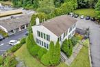 Completely renovated 3-story office building in a prime location, modern upgrades in a private, professional setting. Zoned Roadside Business on two combined tax lots, this property presents an outstanding opportunity for an end user or investor seeking a convenient location with exceptional visibility and room for future growth. The flexible layout includes six private offices (three per floor), a dedicated conference room, a kitchen/breakroom, and bathrooms on each level. One private office is equipped with its own full bathroom. The lower level has been refinished with new tile and is fully conditioned. Parking is never an issue with 12+ on-site spaces plus additional land that can accommodate potential expansion or extra parking needs. Recent renovations completed in 2020 include all new recessed lighting, flooring, and commercial carpeting, paint, trim, and upgraded interior doors. This building is fully wired for todayâ€™s technology demands, featuring Verizon Fios with Static IP, CAT6 cabling, and Ubiquiti networking equipment supporting PoE switching, cameras, and VoIP phones. Security and access with eight cameras (4-interior / 4-exterior) and front door access control with NFC and PIN entry. Exterior upgrades include a repaved driveway, new retaining walls, improved drainage, and a septic tank that has been replaced within the last 8 years.