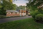 Set on a lush, private acre in the heart of Woodbury, this beautifully maintained Colonial offers timeless curb appeal, generous space, and the kind of quiet privacy thatâ€™s hard to come by. With over 3, 800 square feet, the home features 5 bedrooms, 3 full and 2 half bathrooms, and a flexible layout made for easy everyday living and seamless entertaining. The kitchen is updated with stainless steel appliances and opens into multiple living spacesâ€”whether youâ€™re hosting a holiday dinner or just cozying up by the fire. The standout is the oversized primary suiteâ€”truly are treat of its own. With plenty of space to unwind, a dedicated home office nook, and a private bath, it offers the comfort and breathing room youâ€™ll appreciate every single day. Downstairs, the finished basement with 8-foot ceilings gives you bonus space to make your ownâ€”think gym, playroom, or media hangout. And outside, itâ€™s a true escape: mature landscaping, flat lawn, and an in-ground gas heated pool set the stage for summer lounging or low-key weekends at home. Add in a 3-car garage, top-rated Syosset schools, and a location that feels tucked away yet close to everything, includes a tesla EV plug!â€”this home checks all the right boxes.
