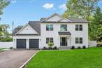 Introducing one of the most elegant, exquisite, and high-end new construction homes to ever hit the market in the highly coveted Smithtown School Districtâ€”this custom-built 4-bedroom, 2.5-bath colonial is set on a private 3/4-acre lot and showcases craftsmanship, design, and luxury at every turn. Set back from the road, the home welcomes you with a private blacktop driveway with cobblestone border, two sleek black garage doors, black gutters, a bold black front door, charming front portico, and premium vinyl siding accented by board and bat soffits for a stunning architectural touch. Step inside to a grand two-story entryway with wide-plank hardwood floors, an extravagant trim and molding package featuring oversized crown molding and extensive box molding throughout, and jaw-dropping shiplap accent walls that run up the staircase and through the second-floor hallway. The formal living room is bright and elegant with box-out windows and detailed wall molding, leading into an expansive great room/den with custom shiplap fireplace wall, wood-burning fireplace, and sliding glass doors that open to your fully fenced white PVC backyard. The outdoor space is a showstopper, complete with a beautiful rear paver patio, front and back inground sprinklers, and lush landscaped grounds. The designer chefâ€™s kitchen is the heart of the home, featuring custom white cabinetry, quartz countertops and matching backsplash, an oversized center island with pendant lighting, black hardware, built-in microwave, and a full Frigidaire appliance package. The formal dining room is nothing short of extraordinary with its coffered ceiling, raised panel box molding, and an abundance of natural light. Upstairs, the palatial primary suite boasts vaulted ceilings, recessed lighting, hardwood floors, a spa-like bath with a white kidney-shaped soaking tub, large glass-enclosed stand-up shower, and a custom walk-in closet with shelving and racking. Three additional spacious bedrooms offer hardwood floors and custom closets, while the second-floor laundry room provides convenience with tiled flooring. Additional features include a full basement with outside entrance, solid 3-box interior doors with black handles, on-demand hot water, gas appliances, two-zone heating and cooling, and full Energy Star certification. This home is the ultimate combination of timeless elegance and cutting-edge luxuryâ€”a true masterpiece built for those who expect nothing but the best.