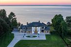 Welcome to Lion&rsquo;s Gate on the Sound, a majestic and impeccably upgraded waterfront estate set on over 3 private, gated acres along the coveted shoreline of the Long Island Sound in Mattituck. This move-in-ready sanctuary seamlessly blends timeless architectural charm with modern luxury, offering a rare opportunity to own one of the North Fork&rsquo;s most distinguished coastal properties. From the moment you arrive, a newly resurfaced driveway winds through electronic gates and a fully updated fencing system, unveiling beutiful grounds designed for ultimate privacy and tranquility. Thoughtful landscape lighting, a lush new lawn, and a restored gazebo-expertly stabilized with masonry work and illuminated for evening ambiance-create an unforgettable first impression. Inside, the home has been meticulously enhanced with freshly sanded and stained hardwood floors and custom details throughout. The sun-filled main level exudes elegance, while the reimagined primary suite offers a true spa-like retreat with a new chandelier, re-grouted showers, and custom niches in each stall. Smart-home convenience is fully integrated, with a whole-house Lutron automation system and new TVs throughout for seamless living. The finished lower level is equally impressive, designed as both a wellness retreat and an entertainer&rsquo;s dream. It features new flooring throughout, a professional-grade home gym with a viewing window to the billiard room, and a stylish custom bar area with leveled flooring and an integrated sink. The attached garage has been upgraded with a gleaming epoxy floor, fresh paint, and smart tech integration-perfect for car enthusiasts or hobbyists alike. Outdoor living is elevated with a brand-new pavilion for al fresco dining, a full irrigation system for lush grounds year-round, and multiple vantage points to take in breathtaking sunsets over the Sound. Whether relaxing by the gazebo, hosting under the pavilion, or strolling the expansive, private grounds, this estate delivers an unrivaled lifestyle defined by luxury, seclusion, and natural beauty. Lion&rsquo;s Gate on the Sound is more than a home-it&rsquo;s a legacy property offering unparalleled privacy, sophisticated upgrades, and sweeping waterfront views. Perfectly located near the North Fork&rsquo;s vineyards, farm stands, and charming village life, this extraordinary residence is ready for its next chapter. Pool Permit Pending.