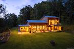 Built by true local artisans, this 2, 500 sq ft modern residence rests on 10 acres with a private walking path to the Coxing Kill creek. Situated in the middle of three separately deeded lots (all with prior BOH approvals), the property offers both privacy and the potential to create a future family compound. Every element of this home was designed for longevity, efficiency, and timeless style. High-quality materials, energy-conscious systems, and custom detailing create a residence that is both functional and beautifulâ€”perfectly framing its natural surroundings. The home features radiant floors throughout (enhanced by passive solar gain in the colder months), on-demand hot water, and four heat pumps for year-round comfort. Additional highlights include a standing seam metal roof, 1, 250-gallon septic system sized for expansion, 320-amp service with a sub-panel (ideal for a future garage, workshop, or pool), spray-foam insulation coupled with Heat and Energy Recovery Ventilation systems. Freshly stained thermally treated wood siding, and custom steel-and-glass casement doors and windows with thermal breaks, The chef&rsquo;s kitchen is a true centerpiece, featuring Thermador appliances, abundant concrete counter space, a wall of custom walnut cabinetry, a wine cooler, and hand-blown pendant lighting. Overlooking the vaulted great room with its dramatic southern-facing windows, this space offers an ideal blend of cooking, dining, and entertainment. Just beyond, the heated four-season porch provides year-round enjoymentâ€”cozy winter views by the fireplace through insulated windows, or breezy summer days with screens swapped in. The first floor includes two bedrooms, each with custom-built-in closets of oak accented by brass and walnut detailing. The southern bedroom is designed for versatility, equipped with a Murphy bed to transform easily from a home gym or office to a guest space. A striking walnut-and-steel staircase leads to the second floor, dedicated entirely to the primary suite. Here, soaring ceilings and another wall of southern-facing glass doors open to a private balconyâ€”perfect for morning coffee. Custom built-ins provide seamless storage, while the spa-like bath boasts a walk-in glass shower, drop-in soaking tub, and double vanity. Outdoors, the thoughtful design continues. A bluestone patio extends the living space into the landscape, with one end featuring a Scandinavian sauna and outdoor shower, and the other an automated pergola and outdoor kitchenâ€”complete with custom cabinetry and sink for preparing produce from the raised-bed garden just steps away. Though self-sufficient in every way, the location offers easy convenience: minutes to High Falls and Rosendale, and only 20 minutes to Kingston or New Paltz. Here you&rsquo;ll enjoy the quiet beauty of the countryside with modern amenities at your fingertips, perfectly balancing the bliss of seclusion with easy access to vibrant Hudson Valley communities.