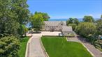 Once in a lifetime waterfront living! Welcome to this spectacular 3.42-acre sanctuary, cocooned in privacy in the exclusive coastal enclave of Orienta. Turn-off. Unplug. Unwind. With a luxurious waterside pool and trellised patio, endless lush lawns, sweeping grounds with serene woods and uninterrupted views of Long Island Sound, this timeless modern masterpiece is in a class of its own. Designed by famed architect Peter L Gluck and featured in Architectural Digest, it boasts a sleek, clean-lined facade that beautifully embraces its waterfront position. Think breathtaking views, grand entertaining, epic sunrises and sunsets, unrivaled firework displays, graceful sailboats, egrets and eagles and the quiet hum of tranquility. Floor-to-ceiling glass offers a powerful visual from the moment you enter, immediately drawing your gaze to the breathtaking shoreline beyond. Art, nature and elegance converge with a dramatic 2-story living room, exquisite family room, striking dining room, chefâ€™s kitchen with sunlit breakfast area and the perfect water-view office. This home is thoughtfully designed with highly-functional spaces â€“ pool changing bath, powder room, oversized laundry, outfitted mudroom and guest or nanny quarters with full bath set privately above the generous 3-car garage. Everything has been thought of here, including an elevator! A full-width waterside balcony spans the entire 2nd-floor, opening from the glorious primary suite â€“ complete with sitting room, 2 spa-like ensuites and boutique walk-in closet â€“ and from the additional ensuite bedroom down the hall. Retreat to the third floorâ€™s penthouse style privacy where sweeping views of the Sound create an unforgettable living space. This level features two bedrooms, each with its own ensuite bath, and a fabulous central lounge with French doors opening to a waterside balcony. Timeless elegance, designed around a chic French-style courtyard, and a backdrop of water and sky. Simply unmatched.