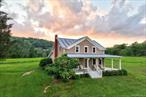 Ensconced in the rolling hills of Obernburg, in the township of Fremont, this 93-acre expanse may be one of the most enchanting blends of forest and pasture to come to market in years. Once the heart of Hillside Dairy, the land carries a quiet legacy of working fields and open sky.The farmhouse dates to 1909 and is ideally situated, tucked away in its own private world at the end of a long driveway off a quiet, dead-end road. A beautiful wrap around porch provides a perfect perch for gazing dreamily out over the verdant rolling hills and sunlit meadows.The property spans across three tax parcels. A local farmer hays the fields, providing agricultural assessments which help keep carrying costs low. There are two ponds, one located in front of the house and the other closer to the driveway. With a little vision, the smaller pond could be expanded, creating an even more dramatic foreground to the farmhouseâ€™s porch-side view.The home itself is the picture of a country farmhouse: simple, warm, and welcoming. A generous dining room, open to the renovated kitchen, serves as the natural gathering place, equally suited for lively dinners with friends or the ease of an everyday meal. The adjoining family room offers a cozier retreat for reading, quiet evenings, or a favorite series. Off the back of the house is a mud room with a wood-burning stove. An enclosed porch also would be a great spot for making into a 3-season hangout.A barn, built in the late 1980s to replace an older structure, recalls its past as the hub of the dairy operation, with a lower level once used for milking and the old milk house still intact. Today, it easily houses tractors, ATVs, or equipment, while also offering space for a new purpose.As for the land itself, it welcomes both vision and restraint. One might carve out equestrian fields, plant an orchard, or allow the retired pastures to remain untouched, a pastoral canvas preserved in its natural beauty. However it is held, this property offers a rare chance to live within history and landscape at onceâ€”private, generous, and deeply rooted in the Catskills countryside.