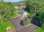This versatile property, located in the Town of Fishkill, is zoned General Business, making it suitable for a wide range of commercial uses. Offering over 4, 000 square feet of space, the building includes 8 spacious rooms, 3 levels including full basement, , 3.5 bathrooms, and a full updated kitchen, providing flexibility for offices, client areas, and staff amenities. The property sits on 1.3 acres, offering ample parking including 17 spaces with handicap and potential for future development opportunities. Permitted uses include medical/dental space, offices for legal, real estate, insurance, accounting, architecture, engineering, and creative studios. Also permitted are hair and nail salons, tutoring services, vocational and technical schools, as well as day-care facilities. This property is especially appealing to licensed professionals seeking to integrate work and a home-like environment in one location. A separate ground floor entrance adds convenience and privacy for clients or staff, while a side entrance to the sunroom creates additional accessibility and flow. The lower level has been updated with brand new carpeting, ensuring a fresh and professional presentation. With a prime location, one mile East of the Village of Fishkill and Route 9 and the Interstate 84 corridor, this property is ideally positioned for visibility, significant Rt. 52 traffic count, accessibility, and growth. Recent updates ensure peace of mind and efficiency, including a new roof (2017), new well pump and repair (2017), electrical upgrade (2019), parking lot lighting (2020), water pump (2021), furnace (2022), water tank (2022), newly paved and striped parking lot (2025), new expansion tank (2025), refinished sidewalks (2025), and LED recessed lighting throughout (2025). Property has underground utilities with natural gas furnace and generator and central air. Property has underground utilities with natural gas furnace and generator and central air. This combination of size, flexibility, location, and modern updates makes it a standout opportunity for a wide variety of commercial applications.