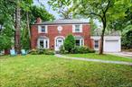 Welcome to this sunlit all brick center hall colonial located in the heart of Great Neck Village. This beautiful home offers a large formal living room with working fireplace, formal dining room, and an eat-in kitchen with doors leading out to the patio and manicured garden. The first floor includes a bedroom and full bath, perfect for guests or office use. Upstairs features a private primary suite with en-suite bath, plus 2 additional bedrooms and a full bath. The finished lower level offers a spacious playroom, laundry, and ample storage. A private, well-manicured backyard provides the ideal setting for entertaining and family living. Conveniently located near schools, parks, transportation, and houses of worship.