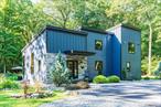This architect designed country home is located at the end of Iron Mountain Road and bordered by Wawayanda State Park. The meandering driveway leads into this private 3.5 acre lovely landscaped property. The property has mature trees, perennial flower gardens, a small Koi pond, a fire pit, small barn, stone walls and trails into the state park. This Modern custom built 2-3 bedroom, 3.5 bathroom eco-conscious homes a one of a kind retreat. The house was designed to minimize environmental impact while offering all the comforts of modern living. Built new in 2020 there are many features such as: board-and-batten Hardy Board & natural Blue Stone siding, metal clad insulated double pane windows & doors with screens, reinforced concrete foundation & basement floor, sustainable EPDM roof, blown-in foam insulation throughout, 4 zone propane high efficiency radiant & baseboard heating system, AC & heat pump units in each room, drilled well water with filtration & softener system, a radon system, a full house generator & much more. The first floor boasts wide board Oak floors throughout, the foyer leads to a 2 story living room open to the dining room, both light filled with walls of windows, the living room has a floor to ceiling Blue Stone wall with a wood burning stove, the dining room facilitates a 8 foot dining table and is open to the spacious kitchen. The kitchen opens into a dining and living rooms where the walls of windows invite in the exterior landscape, flooding the space with natural light. The chef&rsquo;s kitchen features custom made cabinetry, Dekton countertops with a large under-mount sink, high-end KitchenAid black Stainless Steel appliances, including a 6-burner propane cooktop, double ovens, dish washer & a side by side refrigerator. The first floor living room & dining room both have glass doors that lead to a large stone patio & a radiant heated screened-in porch. The first floor Primary bedroom suite includes a large walk-in closet with built-inâ€™s and a spa-like Primary bathroom with a walk-in tiled steam shower, tiled floors, a vanity with a Quartz top and a low flush toilet. Additional first floor amenities include a guest half-bath, a full laundry room, and a built-in surround sound system throughout the main floor, patio, and in all the bathrooms. Upstairs, two bedrooms (one currently used as an office) are complemented by an open loft area and a small bonus room. The second full bathroom features a large oval soaking tub, a tiled walk-in shower, a vanity with Quartz top and tiled floor. All the rooms are light filled and have views of the property. The basement is currently unfinished, it includes a third full bathroom, a mechanical room, a home gym area and storage. This property is located in a very unique location with Wawayanda State Park starting at the end of Iron Mountain Road and bordering the back of this property. The NJ Division of Parks manages the 34, 350 acres of forest. The park has extensive riding and hiking trails, swimming, boating and 19 miles of the famous Appalachian trail. The property is close to Warwick village, with its great shopping, cafeâ€™s, restaurants and boutiques. This is the perfect balance of seclusion and convenience. A rare opportunity to own a full-time or a weekend home only 51 miles from Manhattan, next to a state park and only minutes from a charming village. This is more than just a home â€” itâ€™s a lifestyle. Please see 3D Interactive Floor Plan & Property Tour