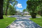 Custom residence perched on a hilltop on 4 private acres overlooking Oyster Bay Harbor. This stunning 6, 933 sq. ft. home offers the perfect balance of elegance, comfort, and modern convenience. Featuring 5 bedrooms and 4.5 bathrooms,  this light-filled home showcases 5 fireplaces, expansive floor to ceiling windows, soaring ceilings, and impeccable finishes throughout. The expansive primary suite is a true retreat, complete with a cozy fireplace, custom closets, and a private terrace with water views, plus a spiral staircase leading to the rear deck. The chefâ€™s kitchen was fully renovated with natural stone countertops, custom cabinetry, and premium GE Monogram appliances. The open layout is ideal for entertaining.Recent updates include a new roof, windows, doors, HVAC system, electric, tankless water heater and all bathrooms ensuring peace of mind for years to come. The finished lower level offers multiple recreational spaces, and is perfect for entertaining or extended living. A home office on the main level provides the ideal work-from-home setup.Outdoors, a new sparkling saltwater pool with stone patio serves as the centerpiece for entertaining, complemented by multiple terraces and newly built retaining walls. A two-car garage with extra storage and updated system adds convenience. Nestled within a coveted private beach community, residents enjoy exclusive beach rights and mooring privileges through the Gracewood Association (fees apply). This is truly Gold Coast living at its finest!