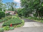 English Tudor surrounded by charming gardens in Manhasset Bay Estates. This nine room classic home features hardwood floors throughout. The first level has inviting living room with wood burning fireplace. Formal dining room with sitting area. Kitchen with marble countertops, gas range and side entrance mud room leading outside to the one car garage. Breakfast room, study, den and a full bath complete the main level. Second floor has two bedrooms,  dressing room and full bath. Wall mounted air conditioners. Full basement with washer and dryer. This property is surrounded by lush gardens with several seating and entertaining areas.Manhasset Bay Estates beach and mooring rights (annual fee applies).