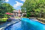Welcome to 98 Spring Pond Lane, a stunning year-round retreat or primary residence in Southampton. Exquisitely updated in 2016 with every detail thoughtfully considered, this 5-bedroom, 5.5-bathroom Colonial offers countless amenities throughout its 5, 000+ square feet of luxurious living space. Upon entering the home, the grand double-height foyer welcomes you into a bright and inviting space. At the center of the home is a sun-drenched living room featuring a soaring ceiling, fireplace, and double French doors that open to the expansive. To the left, the den that boasts a custom wet bar and a gas fireplace, and a private first-floor bedroom with an ensuite bath. To the right, you&rsquo;ll find spacious formal dining room and a custom chef&rsquo;s kitchen outfitted with premium Sub-Zero and Wolf kitchen appliances, a large center island, and dining area.  The second floor is home to the grand primary suite with pond views, complete with vaulted ceilings, a mezzanine, dual walk-in closets, and a luxurious ensuite bathroom featuring an oversized shower. Two additional bedrooms on this level include one with panoramic views of the picturesque backyard, and another with access to a shared full bathroom. The third level offers a versatile bedroom space and finished storage.  The lower level features a dynamic media room with tiered theater seating, a custom golf media center with state-of-the-art simulator, a full bathroom, and a spacious 3-car tandem garage with custom Vault cabinetry.  Outside, the highlight is the resort-style heated gunite pool, complete with a spa, double-waterfalls, and an incredible custom waterslide. The lush manicured grounds are designed for relaxation and entertainment, featuring an expansive deck, a pergola, a bluestone patio, a fully equipped outdoor kitchen with wraparound seating, and a gas fire pit. At night, gas tiki torches and landscape lighting set the perfect atmosphere for evening gatherings. Modern conveniences abound with smart-home features including a Control4 automation system, 12 Sonos sound zones for indoor and outdoor enjoyment, a 15-camera surveillance system, and smart thermostats throughout. Spring Pond Lane also offers 3 community tennis courts and sits moments away from pristine beaches and world-class golf courses. This home truly has it all. Don&rsquo;t miss the opportunity to own this one-of-a-kind property in Southampton.