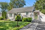 Welcome to 54 Rowland Street, nestled in the desirable Canaan Lake area of Patchogue. This charming three-bedroom Cape Cod features a beautifully updated kitchen with stainless steel appliances, quartz counters, subway backsplash and a walk-in pantry, an updated bath, a spacious living room, and a dining area with hardwood floors throughout. Plantation shutters add elegance to every room, while central air ensures year-round comfort. The finished basement provides the ultimate entertaining space, and outside youâ€™ll find a fully fenced yard with a deck, a gorgeous paver patio, and a detached two-car garage. From this special location, you can even enjoy kayaking on scenic Canaan Lake. Additional highlights include a roof replaced just five years ago, new cesspools installed in 2019, a five-zone Hunter sprinkler system, and a new Roth galvanized oil tank. Located within the Patchogue-Medford School District and offering very low taxes of $6647.18 before basic star rebate, this home is truly a must-see!