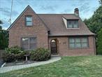This beautiful home is a completely updated Brick Tudor on a Dead End street walking distance to schools, LIRR, shopping and more! It has a tremendous yard for entertaining with a large shed for storage, a 1 1/2 car garage and a 4/5 car driveway. Updates include a new spacious kitchen with white cabinets, an updated full bath with jacquzzi tub, a beautifullly updated half bath with Wainscoating, an architechural roof, anderson windows, 200 amp electrical service panel, only 2 year old updated gas heating system, beautiful mantle over wood burning fireplace in a large livingroom with hardwod floors, large formal dining room with hardwood floors, 3 nice sized bedrooms all on the second floor and a huge unfinished basement with front loader washer & dryer. All of this but wait you will find many orignals like solid wood crafted doors with brass knobs and key holes, a square solid wood bannister, reflections to remind us that homes have history! Come make your dreams come true in this truly lovely home! This house is clean as a whistle and move in ready. Just bring your clothes & furniture. A must see!!! Join me at my Public Open House on Sunday, September 7, 2025 from 12:00 pm to 3:00 p.m. Hope to see you there!