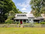 Introducing Woodbine Cottage, a storybook Colonial built circa 1800, filled with old world character and timeless charm. Located in the vibrant hamlet of North Chatham, this well-preserved residence offers three bedrooms, two bathrooms, and a thoughtful balance of period craftsmanship and modern updates. Perennial gardens and a quaint fenced yard enhance the cottageâ€™s fairytale quality, making it feel worlds away. Inside, every detail tells a story. Wide-plank wood floors, timber beams, an original mantle, and hand-hewn iron latches speak to the homeâ€™s early heritage, complemented by thoughtful updatesâ€”a refreshed kitchen with new flooring, renovated bathrooms, modern appliances, and updated lightingâ€”that bring ease without compromising its antique charm. The ground-floor primary suite offers comfort and convenience, and sunlit gathering spaces flow naturally for quiet moments and entertaining.Outside, the sweet dormer windows, columns, and metal roof are reminiscent of an English country cottage. Two front porches provide quiet nooks to sit and take in village life, and the fenced backyard is a true retreat. A pergola draped with grapevine and honeysuckle partially shades the brick patio, which overlooks the landscaped lawn and perennial gardens brimming with lilies, anemones, black-eyed Susan, and phlox. The detached two-car garage adds practicality, with space for parking and generous storage for garden tools, bicycles or weekend projects. Set in North Chathamâ€™s historic district, the property is surrounded by handsome 18th- and 19th-century homes and a welcoming, conservation-minded community. The hamlet is anchored by the beloved North Chatham Public Library, which hosts cultural programs and fosters a strong sense of connection. Just 10 minutes to Chatham Village, 20 minutes to Albany, and 30 minutes to Hudson, youâ€™ll enjoy idyllic small-town living with easy access to restaurants, farmersâ€™ markets, cultural attractions, and all the beauty of the Hudson Valley.