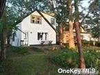 Live as if on vacation. This charming waterfront home offers spectacular views of Port Jefferson Harbor. Poquott Village Offers a community tennis/pickle ball court as well as a community dock. Beach house on your shoreline.