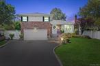 Welcome to this spacious split-level home tucked away on a quiet cul-de-sac in Seaford with Levittown schools. This home offers a versatile layout featuring an inviting living room, formal dining room, and a bright eat-in kitchen with access to the yard. The open layout is perfect for everyday living and entertaining. The sunlit den also provides direct yard access through the sliding doors and plenty of space for gatherings and can also be utilized as home office space. Upstairs, the primary bedroom includes a private ensuite bath, while hardwood floors flow throughout, adding warmth and charm. A partially finished basement offers flexibility for work out space or an exercise room, and the large garage provides storage and indoor parking. The cul-de-sac setting allows for an oversized yard, creating both privacy and outdoor enjoyment.
