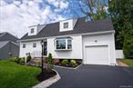 Beautiful, newly-renovated cape cod home in Massapequa Park. Newly refurbished oak floors throughout, crown moulding, family room with wood burning fireplace and 2 skylights, fully-renovated eat-in-kitchen with all new appliances and countertops (under cabinet lighting), renovated full bathroom on first floor, living room, formal dining room, first floor bedroom, large pantry/mudroom with indoor access to 1-car garage (with 10ft ceiling), covered deck in landscaped backyard, 2 large bedrooms upstairs with closets, including cedar closet and walk-in attic storage room, fully renovated upstairs bathroom with glass shower, full basement with plenty of potentialExterior: top-of-the-line hardie board shingles in front, vinyl siding around remainder and newer roof, and 5-zone sprinkler system Closing to shopping, park and train station