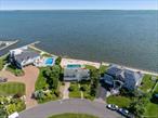 Bayfront home perfectly positioned on the Great South Bay, offering a rare and coveted lifestyleâ€”where only a limited number of residences sit directly on the open bay. Nestled on a quiet cul-de-sac, this property boasts panoramic water views, 130 feet of bulkhead, and a resort-like setting complete with a heated pool and expansive outdoor space that truly captures the essence of waterfront living. This beautifully appointed home features 3 bedrooms, 3.5 bathrooms, Eat-in-kitchen, a 2-car garage, central air conditioning, and a spacious primary en-suite with breathtaking views. Additional highlights include hardwood floors throughout, a cozy den, and two fireplacesâ€”all situated on a generous 0.40-acre lot. As a resident, you&rsquo;ll also enjoy access to exclusive Willetts Point Private Beach Club, offering a range of amenities and a true sense of community and coastal living for its members.