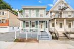 Charming two-family home in East Yonkers with classic rocking chair front porch. The first floor features two bedrooms, a sunlit living room, and a separate dining area. The second floor offers an oversized bedroom-which can be converted back to two separate bedrooms, large eat-in kitchen, a balcony off the living room, and ample closet space including a walk-in closet. A new boiler has been recently installed. The property also includes a large two-car garage with loft storage. Centrally located near major highways, public transportation, Cross County Shopping Center, restaurants, and just a short walk to Fleetwood Metro-North Station. Home needs some TLCâ€”bring your imagination and make it your own!