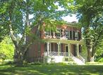 Welcome to Schoolfield â€“ A historic Germantown Estate on Woods Road. This a rare opportunity to own a piece of history less than a half mile from the village of Germantown. The stunning 4, 320 sq ft transitional Greek Revival / Italianate brick home dates back to 1850 and is situated on 7+ sprawling acre on the north end of highly desirable Woods Road.Strolling the manicured grounds, you&rsquo;ll be captivated by the gorgeous, formal English gardens and perennial flower beds that surround the home and outbuildings, providing a picturesque backdrop for outdoor gatherings or quiet moments of reflection. The lush landscape features a mix mature trees, dramatic daffodil fields, a wisteria-covered gazebo, open meadows and a wooded area which combine to create a serene oasis and contribute to the propertyâ€™s natural beauty & privacy. The interior of the meticulously renovated main house lies on 3 levels. The soul of the home is the immense, chef&rsquo;s kitchen, equipped with Wolf and Sub-Zero appliances and includes a separate informal dining area perfect for entertaining while cooking. The double parlor, flanked by two elegant fireplaces, creates a warm and inviting atmosphere for large gatherings or cozy evenings, while both the formal living and dining rooms exude classic charm and elegance. An additional cozy library/office provides an ideal space for work or quiet reading.The expansive primary suite is a true retreat, featuring a beautiful marble bathroom that adds a touch of luxury. In addition, there are four spacious guest bedrooms and three newly updated marble bathrooms, along with a convenient powder room for guests.  For entertainment and relaxation, enjoy the massive, windowed media room with its own bathroom on the lower level that offers ample space for movie nights. In addition to the main residence, the property includes a historic schoolhouse that serves as a perfect work studio or writer&rsquo;s cottage, offering a peaceful space for creativity and inspiration. A massive barn provides ample storage and potential for various uses, whether for hobbies, animals, or possible entertainment venue.Located just half a mile from the center of Germantown, youâ€™ll enjoy easy access to charming shops, delightful restaurants, and local amenities. Experience the best of both worlds with the tranquility of country living and the convenience of nearby urban conveniences.Donâ€™t miss this unique opportunity to own a historic property with modern elegance and endless potential. Schedule your private tour today and discover the beauty and charm of this remarkable estate!