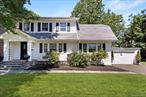 Welcome to a timeless Dutch colonial in Highland Park, New Rochelle. Masterfully renovated by designer Carmen Marc Valvo. This charming 1918 home blends historic character with modern luxury. The gracious vestibule welcomes you to a powder room, a living room with a wood-burning fireplace, and an adjoining family room with access to the attached garage. French doors lead from the dining room to a glass-enclosed sun porch. The newly redesigned kitchen offers modern style and functionality, with stairs leading to the expansive backyard. The second level features a luxurious primary bedroom with an en-suite bathroom and a spacious walk-in closet, as well as two additional bedrooms and a hall bathroom. The third floor features a fourth bedroom, a full bathroom, and storage space. The basement includes laundry, utilities, and storage. Enjoy outdoor living in the enormous backyard with a park-like feel.