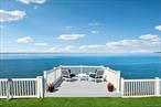 Breathtaking Waterfront Estate on the Long Island SoundPerched high on a dramatic cliff overlooking the Long Island Sound, this extraordinary residence offers sweeping, unobstructed water views and a private beach in one of the North Shoreâ€™s most coveted communities. Set above the shoreline, the property enjoys both a front-row seat to breathtaking sunsets and complete peace of mind with no risk of flooding.Spanning approximately 6, 000 square feet across three beautifully finished levels, the home features 5 spacious bedrooms and 4.5 luxuriously renovated baths. Every detail has been carefully updated, including a chefâ€™s kitchen with top-of-the-line appliances, custom cabinetry, and sleek finishes, as well as spa-inspired bathrooms designed with modern elegance in mind.Flooded with natural light, the interiors showcase an open flow that seamlessly connects formal entertaining spaces with more relaxed family living areas, all designed to maximize the stunning water views. Multiple oversized windows bring the outdoors in, while expansive living and dining rooms create the perfect setting for both intimate gatherings and grand celebrations.This is more than a homeâ€”itâ€™s a private coastal retreat, offering the rare combination of privacy, luxury, and access to a vibrant, highly desirable community.