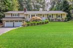 Opportunity awaits with this ranch style home which offers a possible mother/daughter opportunity close to the heart of Smithtown. Enter in the home and you will step into an open space perfect for entertaining, the area offers an L-shaped Living room, Dining room, a Fireplace and Kitchen, all with hardwood flooring. The kitchen features stainless steel appliances, quartz counter tops and a two tiered island that has bar top seating. On one side of the home there are 3 bedrooms all with hardwood flooring and full hall bath. One bedroom has a private half bath perfect for more privacy if needed. The large private Primary suite is located steps from the dining room. It features a primary bath, walk in closet and hardwood flooring. The beautiful basement is fully finished with summer kitchen, full bath, laundry, egress window and entertainment area, perfect setup for a potential mother/daughter. The rear yard features an inground pool with ample paver surround for all your summertime fun.