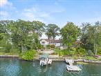 Exceptional Candlewood Isle waterfront home with panoramic lake views. Discover unparalleled lakeside living in this extraordinary Candlewood Isle waterfront home, boasting approximately 220 feet of direct lake frontage with western exposure and amazing sunsets. Set on a beautifully landscaped .74-acre lot, this property is a rare blend of serene natural beauty and sophisticated design, ideal for both grand entertaining and peaceful retreat. Step outside to enjoy multiple stone terraces, bluestone patios, and vibrant gardens with breathtaking views of Candlewood Lake. A private dock wiith floating swim dock invites endless waterfront fun, while tiered outdoor spaces offer the perfect setting for relaxing or hosting gatherings. Inside, the open-concept layout is thoughtfully designed to highlight the home&rsquo;s natural surroundings. The spacious living room with wood-burning fireplace flows seamlessly into a sun-drenched sunroom, where floor-to-ceiling windows capture panoramic lake vistas. A cozy library nook adds charm and warmth, while the gourmet granite kitchen connects effortlessly to the dining room and a stone terrace, creating a natural extension for indoor-outdoor living. The large primary suite serves as a private sanctuary with sweeping lake views and his and her natural stone bathrooms. Complementing this are additional accommodations, including a Jack & Jill guest rooms and dedicated home office. The lower level has two additional bedrooms that can act as a private suite with full bath, versatile multiple media area and entertainment space and a glass-enclosed garden sunroom. Additional features include central air conditioning, three separate entrances, an attached two-car garage, a garden shed, plenty of parking and impeccable curb appeal. Just 60 miles from Manhattan, this exceptional home offers year-round enjoyment with access to exclusive Candlewood Isle amenities such as tennis courts, a private beach, clubhouse, and an optional children&rsquo;s summer camp making it the ultimate lakeside retreat for both adventure and tranquility.