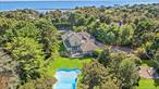 Situated South of the highway, in the prestigious Sandringham Beach community, this recently built and beautifully finished contemporary home has it all! The property includes deeded access to a private neighborhood beach on Shinnecock Bay and water access on Old Fort Pond where you can moor a boat or launch canoes, kayaks, and paddle boards. Set on a lush 1.40 acres of mature landscaping with multiple terraces for entertaining, this property includes a heated free-form pool, koi pond, and a full-size sunken deco-turf tennis court. The 5800 square foot house includes 6 bedrooms, 5.5 baths, study, chef&rsquo;s kitchen with Viking appliances, great room with wood-burning fireplace, formal dining room, three season room, and a finished lower level with a wet- bar and infra-red sauna. The master suite with its own fireplace is situated on the first floor and there are five additional spacious bedrooms and a bonus room/den for overflow guests. The house has energy-efficient appliances, a smart home system with Lutron automatic shades, and 10 kWh of solar installation: so low electric rates. The South of the Highway location provides an easy commute from Manhattan and is only two miles from Southampton Village and minutes away from the Ocean and famous Coopers Beach. Proven rental history of $225, 000 for the summer season., Additional information: Appearance:Excellent, ExterioFeatures:Tennis, Interior Features:Lr/Dr, Marble Bath, Separate Hot water Heater: