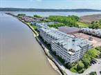 In one word - exquisite. Experience the ultimate in riverfront living at this stunning two-bedroom, two bath condo located directly on the walkway to the Pier in the charming village of Piermont. Set within the historic Robert Gair Paper Factory, this one-of-a-kind home offers breathtaking, unobstructed views of the Hudson River through walls of windows that flood the space w/natural light. No expense has been spared in the complete, high-end renovation. The architecturally designed, contemporary kitchen features custom two-tone cabinetry, a spacious center island w/a Subzero beverage center, quartz countertops, & professional-grade appliances, including a Subzero French door refrigerator, Wolf wall oven, induction cooktop & Miele dishwasher. Both spa-inspired bathrooms are finished w/designer tile from Porcelanosa & Artistic Tile, creating sleek, modern retreats. A thoughtfully designed laundry room w/custom cabinetry & quartz counters adds function & style. Entertain year-round in your enclosed, heated terraceâ€”an add&rsquo;l 315 square feet of living spaceâ€”finished w/luxury vinyl plank flooring & sweeping Hudson River views. The common charges include a full time concierge, an indoor pool, clubhouse, fitness center, tennis & pickleball courts. All utilities except electric & cable are included as well. Two indoor parking spaces & a double storage unit are an added bonus. Just steps away from the unique shops & flavorful restaurants in Piermont, this condo is more than a homeâ€”itâ€™s a lifestyle that&rsquo;s calling for you!
