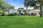 Located in Patchogue Village, this frame-built ranch offers 3 bedrooms and 1.5 bathrooms across 1, 494 square feet of interior living space, set on an 11, 761 square foot lot. Built in 1963, the home balances original character with some updates.The main living room features cathedral ceilings that enhance the sense of openness and height, along with a wood burning fireplace that adds natural warmth and ambiance. Sunlight filters through the home from its two skylights, highlighting the scale of the ceilings and the flow of the layout. The kitchen is equipped with newer appliances and offers a functional workspace with built-in eat-in area. Comfort is maintained year-round with forced air heating and central air conditioning.Additional interior features include a full unfinished basement providing storage or workshop space, as well as a scuttle attic for convenient overhead access. The property also includes an attached 1.5-car garage, accommodating both parking and storage needs.The lot provides room for outdoor use, with a footprint that complements the homeâ€™s layout and garage placement. The frame-built design reflects the homeâ€™s sturdy construction while maintaining the single-level convenience of a ranch.Situated close to downtown Patchogue, the property offers access to shopping, dining, and local amenities. The Long Island Rail Road is also nearby, providing transportation options for commuting or travel throughout the region.This residence combines a practical layout, established construction, and a location within Patchogue Village that provides both neighborhood character and convenience to community resources.