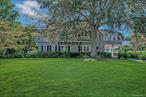 An estate of distinction awaits at 242 Handsome Avenue, where timeless architecture meets modern luxury, in the heart of South Sayville. Set on 1.2 manicured acres, with New Driveway and Stately Slate roof this 5, 400 sq. ft. residence with an accompanying artist cottage has been masterfully designed for both grand entertaining and everyday elegance. 6 bedrooms, 4.5 baths, Custom kitchen featuring imported granite, premium appliances, and bespoke millwork. Elegant entertaining spaces include a formal dining room, living room, sitting room, breakfast room, bar room, den, and sunroom. Refined details throughout: extensive molding, wainscoting, hardwood floors, and slate/marble floors with radiant heat, all marble primary bath retreat with jetted Jacuzzi tub and separate toilet room. Elevator, upstairs laundry, and full attic add convenience and functionality. Professionally designed grounds, fully fenced with a 22-zone irrigation system and 20â€™ x 40â€™ heated saltwater gunite pool with retractable cover. Artist Cottage with half bath and much more. A Car Enthusiastâ€™s Dream- 8-car detached garage with loft and staircase Plus 2-car attached garage with gym, provide ample secure storage for collections, recreation, and entertainment. South Sayville is synonymous with refined coastal living. Minutes away from marinas, beaches, and Sayville Villageâ€™s charming boutiques and restaurants. With The Great South Bay as your backyard playground, boating, sailing, and waterfront recreation are never more than moments away. This is more than a home, it is a South Shore legacy estate, offering privacy, luxury, and a lifestyle that few can claim.