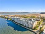 Waterfront Penthouse, Piermont, NY! Located in the area&rsquo;s only Gated Waterfront Community, this Luxury DUPLEX offers nearly 2, 100 square feet of sunlit living space. With Four-Season views of Tallman Mountain State Park and the Hudson River, this Penthouse boasts 2 principal bedroom suites, a deck, 2.5 baths, and 2 walk-in closets--one of which is 8 x 18 feet! Additional features include an expansive, open-concept Living-Dining Room with hardwood floors, gas fireplace, and deck access. The adjacent kitchen is well-equipped with granite counters, stainless steel appliances, and a large, walk-in pantry for additional storage. The 1st floor Primary Bedroom features a marble bath with dual vanity, soaking tub, and separate walk-in shower. A pocket door leads from the Bedroom to a separate closet office. The spacious upstairs Primary Suite features a comfortable sitting room with Stunning Views of the Hudson River and Tallman Mountain State Park. The upstairs en suite suite marble bath has a dual vanity, jetted tub, and separate walk-in shower. You&rsquo;ll fall in love with the extraordinary 8 x 18&rsquo; walk-in closet with generous space for all your more personal possessions! A private laundry/utility room and a downstairs powder room completes the layout. Residents enjoy a number of luxury amenities, including Concierge and Porter services and Membership in the Private Health Club with indoor, heated pool, spa, gym, and tennis & pickelball courts. 417 Harbor Cove also comes with indoor parking for 2 cars and a storage unit. Nearby, enjoy the charming Village of Piermont restaurants, shops, galleries, and marina. There&rsquo;s a reason why Piermont is a weekender&rsquo;s much-loved destination! Ideally located only 15 miles from New York City, make this home your perfect Weekend Retreat, 7 days a week. Convenient transportation to New York City leaves directly from the village.