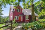 A magical retreat surrounded by 14 acres of protected, forever-green land, with mature pine forests on two sides and a year-round flowing trout stream with a deep swimming hole. This charming farmhouse-style home, lovingly cared for by the same owners for 30 years, offers 3 bedrooms + office and 2 full baths.The heart of the home features a stone fireplace, built-in bookcases, and vaulted ceilings. The family room showcases custom stained glass and a cozy, inviting atmosphere. The open kitchen overlooks the stream, mature plantings, and a thriving vegetable garden, surrounded by flowering trees and shrubs including dogwood, catalpa, weeping cherry, rose trees, blueberries, and raspberries. Garden sheds and a full walk-up attic provide extra storage.Updates include a new heat pump and AC, hot water heater, insulation, Andersen windows, and professionally maintained interior and exterior paint. A first-floor bedroom and full bath are ideal for guests, while the primary bedroom offers sweeping night-sky views. The updated full bath includes a sauna. You will be surprised and delighted to discover Quail Ridge just 50 miles from NYC and it feels like its own peaceful secluded retreat tucked away yet still close to everything. Situated on a quiet dead end with no drive by traffics. No flood insurance required, stream not near the house.