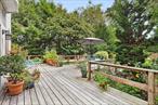 Set off the road, on the fringe of Sag Harbor Village, with a sidewalk path to parks, shops and restaurants, lies this gem of a property with beautifully natural gardens, a goldfish pond and stone waterfall. Three bedrooms, two baths, generous deck, and likely, room for a pool. You want to see this!