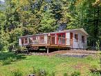 Peaceful 2-Bedroom Home in West ShokanSet on nearly an acre in the heart of Catskill Park at the foothill of Peekamoose Mountain, this 2-bedroom, 1-bath home combines comfort, character, and natural beautyâ€”fully move-in ready with thoughtful updates throughout. Inside, you&rsquo;ll find newly refinished hardwood floors, fresh paint, and a functional kitchen with brand-new appliances plus a new washer and dryer. An additional roomâ€”ideal for a home officeâ€”shares space with the laundry area and opens directly to the outdoors.The light-filled living area features striking mid-century built-in shelving and a cozy wood stove capable of heating the entire home. Step outside onto the spacious deck overlooking the gardens, a perfect spot for relaxing or entertaining.Recent practical upgrades include a new roof, a new retaining wall to the garage, and a new oil tank, ensuring both comfort and peace of mind.Surrounded by the natural beauty of Catskill Park, this home would be a perfect full-time home or a tranquil retreat just minutes to Peekamoose Blue Hole, Davis Park for swimming, the Ashokan Reservoir and Rail Trail, hiking trails, ski resorts, and many of the charming villages the Catskills have to offer. Property is NOT in a Flood Zone per Fema**