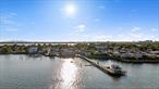 Yes, you can have it all! Discover the perfect blend of style, comfort, and security in this beautifully maintained tri-level residence located within City Islandâ€™s premier gated waterfront enclave. This turnkey 2-bedroom, 2.5-bath home offers modern upgrades, spacious living areas, and breathtaking water viewsâ€”all designed for effortless, upscale living.The main level encompasses a light-filled living and entertaining space, step into a sun-drenched open-concept living and dining area featuring rich 1/2 inch engineered oak flooring and abundant natural light. The inviting living room boasts a cozy wood-burning fireplace and sliding glass doors that lead to your private balconyâ€”ideal for relaxing with views of the in-ground pool and the sparkling Long Island Sound. The chefâ€™s kitchen is a standout, equipped with top-of-the-line appliances including a Viking 6-burner gas range, Bosch dishwasher, French door refrigerator, granite countertops, and solid wood soft-close cabinetry. An oversized kitchen window brings in additional sunlight, while a stylish updated powder room adds convenience for guests.The second floor offers a spacious primary suite with spectacular water views, oversized windows, a Juliette balcony, generous closet space, and a fully renovated ensuite bathroom featuring a walk-in shower and elegant marble tile flooring. The second bedroom is equally bright and roomy, with two large closets and oversized windows. A beautifully updated hall bath with skylight serves the second bedroom, along with a separate laundry area featuring in-unit washer/dryer, linen closet, and utility closet for added convenience. Custom finishes throughout include crown molding, 3/4 inch solid oak floors and premium Graber window treatments. This home offers modern convenience with central air, forced heat and in -unit laundry, tandem garage parking space, which includes a 120V 20 amp outlet that has been permitted for a class 1 EV charger, and a storage shed.Beyond the residence, enjoy resort-style amenities: an outdoor in-ground pool, a pickleball court, a waterfront clubhouse for your private entertaining needs, dock and direct access to the Long Island Sound, a unit exclusive private mooring is fully transferable. With beach, golf and horse riding facilities near by relax and enjoy this wonderful gated community with 24-hour security and gatehouse attendant.Enjoy the tranquility of waterfront living without sacrificing access to the city. You&rsquo;re just minutes from schools, local shops, restaurants, and multiple transit options including, express bus service to Manhattan, city bus to the #6 subway line and easy access to major transportation links.Your waterfront lifestyle awaits at 21 Deepwater Way. Schedule your private showing today!