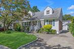 Beautifully maintained center-hall wide line Cape with 3 bedrooms, 2 full baths, and approximately 1, 800 square feet of living space. The first floor features a living room with gas fireplace, formal dining room, spacious eat-in kitchen with generous cabinetry, Quartz countertops and stainless-steel appliances, a family room (can easily be used as an additional bedroom) and a thoughtfully renovated full bath. On the dormered second floor you&rsquo;ll find a massive primary bedroom with two walk-in closets, two other generous bedrooms and a second updated bathroom. The spacious full basement creates valuable bonus space and an abundance of storage. A cozy welcoming back patio provides outdoor living that overlooks the landscaped 50&rsquo; x 100&rsquo; lot. Set on a quiet residential street, just blocks from the park and close to shopping, dining, and direct transportation options into Manhattan, this property combines updates, space, and a location thatâ€™s hard to match. A must-see for buyers seeking a comfortable home with character and charm.