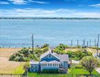 Experience dramatic seascapes year-round in this charming, old-fashioned beach house nestled in the tranquil and quaint Oak Beach community, just steps from the Fire Island Inlet. This 4-bedroom coastal retreat features a spacious deck,  unobstructed views of the inlet, an oversized yard with parking for at least 6 vehicles (plus room for a small boat), and a cozy sunroom with shoreline views, perfect for relaxing mornings or lazy afternoons. The inviting living room is graced with the ambience of a wood-burning fireplace with insert, ideal for chilly nights. Upstairs bedrooms offer breathtaking views of either the Great South Bay or the iconic Robert Moses Bridge. Immerse yourself with the beauty of nature in the neighborhood,  lined with Fire Island-style boardwalks, creating a unique, serene atmosphere. Paddleboard, kayak, fish, or bike along the nearby Ocean Parkway Coastal Greenway. Long Islandâ€™s best beaches and parklands are just minutes away. Take time to rest, relax, recreate and enjoy time by the sea with the ease of a 50-minute commute from NYC or a short ride from the LIRR. Come explore this magical escape and make Oak Beach your forever getaway. Serenity now!