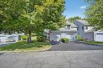 Welcome to 97 Jonathan Drive in the desirable Society Hill community of Mahopac. This beautifully updated townhouse offers 2 spacious bedrooms, 2.5 bathrooms, and a comfortable layout designed for modern living. The open-concept living room and dining room feature a cozy fireplace and sliders leading to a private deck overlooking a wooded backyard, perfect for relaxing or entertaining. The kitchen has been updated with new flooring, counters and appliances. The laundry/mudroom is conveniently located as you enter from the garage. A tastefully updated half bath completes the first floor. Upstairs, each bedroom has plenty of closet space, the primary with a walk-in. Both bedrooms have en-suite bathrooms that have been tastefully updated. The home has been refreshed throughout with new paint, carpeting and tiled floors. Driveway has been newly coated. Enjoy low-maintenance living with access to Society Hillâ€™s amenities, including a sparkling pool, tennis courts, and a playground. Conveniently located near shopping, dining, schools, and major highways, this move-in ready home is ideal for anyone seeking a vibrant yet peaceful lifestyle in Mahopac.