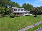 Looking for a spacious home in a community setting that offers a friendly suburban neighborhood with an urban feel? If yes,  this 6 Bedroom 3 Full Baths, custom built Colonial Home is the one for you. A Corner lot with Rocking Chair front porch surrounded with beautifully landscape design in both front and back yards. Welcoming spacious foyer that leads to generous size Living Room, Formal Dining Room, and Eat-in-Kitchen with separate pantry area,  plenty of counter space and cabinets, Family Room with fireplace and sliding glass doors permitting seasonal views of the sprawling backyard and oversized patio. The same level also features 2 Bedroom which can be used as guest rooms or home office., full Bath, Laundry area and entrance/exit to 2 car garage. Upstairs features oversized Primary bedroom suite with walk-in closet, 3 more generous size Bedrooms and 1 full bath. Hardwood floors under carpet. New Hot Water Heater( 2025), A/C condenser (2024),  Roof (2021) Gutters (2024). Conveniently located to Town Pools, Restaurants, Shops,  public transportation and the much sought after Clarkstown School District. This home was custom built with convenience and comfort in mind.