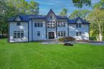 Stunning Fully Remodeled Hampton-Style Colonial.Perched atop a hill on a lush acre, this 4-bedroom, 2.5-bath Colonial blends classic elegance with modern luxury. The grand foyer with soaring ceilings opens to sun-filled living spaces, an open-concept living room, and a formal dining room perfect for entertaining. The master suite features a spa-like bath, walk-in closet, and serene property views. Outside, enjoy private, park-like grounds with room for a pool. Additional highlights: hardwood floors, central AC, gas heat, attached 2-car garage, and full unfinished basement with expansion potential. Minutes from Sunken Meadow State Park, Callahans Beach, and Indian Hills Golf Clubâ€”move-in ready and turnkey!