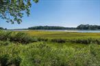 A waterside conversion by ECKSTROM.Welcoming this sleek, light-filled modern beauty to the market!Set on a peaceful bay view oasis, this captivating home has been fully rebuilt withECKSTROM&rsquo;s signature minimalism and timeless design.Floor-to-ceiling glass frames sweeping views from Mud Creek to Peconic Bay, while arooftop deck immerses you in nature preserves and sunsets that feel like live art.Inside, natural materials take center stage with wide-plank Dinesen Douglas Fir floorsfrom Denmark, custom Shinnoki oak cabinetry, and mineral Caesarstone countertops.Bathrooms showcase terrazzo and ceramic finishes with a soaking tub for true retreatvibes. Every beam, system, and window is brand new, crafted to the highest standards.An open-plan studio with roof deck offers endless inspiration, while a pool permit, plusproximity to the causeway beach and Strongs Marina complete the lifestyle. Sleek, serene, and built for both entertaining and unwinding...This is North Fork Zen at its finest.