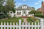 This beautifully maintained home offers the perfect blend of charm and comfort. From the moment you arrive, youâ€™ll be welcomed by lush landscaping and a classic white picket fence, creating a warm and inviting curb appeal.The Cape-style layout features a spacious living room, an expanded kitchen, and a full basement. In addition to two upstairs bedrooms, the first floor includes two more bedrooms and a full bathroom, ideal for convenient main-level living.Outside, the backyard oasis includes a detached garage and an above-ground pool, perfect for summer fun and entertaining.Conveniently located near parks, schools, shopping, and major roadways, this home offers an ideal mix of privacy and accessibility. Donâ€™t miss the opportunity to make this charming property your own.