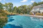 Welcome to exceptional indoor and outdoor living. Set on a private 1.5 acres and surrounded by mature trees, this home features incredible outdoor spaces ideal for entertaining or relaxing in total privacy. This custom home offers an impressive stone facade set in granite and stone column entry is set privately and situated on 1.5 acres in an ideal Southern Yorktown location with Yorktown schools. Step inside this home and feel how open and light-filled the entire main living level with sun drenched rooms, windows galore and distant views. Let the sunshine in on the recently refinished hardwood floors, the open floor plan is flexible and smartly designed with spaces for dining, open living room and a stunning kitchen designed for the serious cook with side and rear decks to enjoy the outdoors those distant views. The kitchen has storage galore with a pantry closet and custom cabinetry, professional-grade oven/range and finished with granite tops with large center island. Whether for daily needs or special occasions, this kitchen will perform quite capably, and the cook will appreciate the beautiful views. This home offers a remarkable amount of indoor-outdoor flow, including access to a rear deck and a side deck off the kitchen, just a perfect spot to enjoy your morning coffee. The owner&rsquo;s suite has ample space and includes an on-suite bath. The finished lower level provides a family room, home office or guest room with a summer kitchen and full bath. Itâ€™s the perfect setup for guests or the extended family. 986 Cliff Avenue is an ideal residence for the buyer seeking a thoughtfully designed house offering privacy, home office and recreation spaces, including an impressive stone saltwater pool with waterfall. Set in an ideal location and just a few minutes to town shopping, restaurants, access to the county bike trail and close proximity to schools, hiking trails, town parks and parkway.