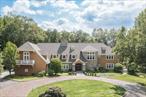 Just one hour from Manhattan, this extraordinary Bedford Corners estate offers the ultimate in privacy, scale, and resort-style living. Encompassing 14, 000 square feet of custom design on 11.27 gated acres, the residence combines timeless sophistication with every modern amenity. Perfect for either a primary or weekend residence. A Retreat for Living, Working and EntertainingThe grand entry opens to sunlit living spaces and a dramatic 20-foot ceiling family room, anchored by a soaring floor-to-ceiling stone wood burning fireplace. Expansive entertaining rooms flow seamlessly to outdoor terraces and landscaped grounds. A grand formal dining room accompanied by a newly renovated chefâ€™s kitchen sets the stage for both intimate dining and large-scale entertaining. For work or study, a distinguished office /library, richly finished in teak wood, with a wood burning fireplace provides a warm and refined setting - ideal for remote work, private meetings or quiet reading. Luxurious Private QuartersThe residence features six bedrooms, including a serene primary suite with a wood burning fireplace, private sitting room, enclosed porch, and dual custom dressing rooms. Two bedrooms are located on the main level for flexibility, while the upper level offers four additional bedrooms plus a bonus media/theater room. An elevator services all floors for effortless convenience.Resort-Style AmenitiesDesigned for year-round enjoyment, the estate offers an unmatched collection of amenities:Outdoor pool & spa with expansive stone terracesAir-conditioned pool house with full kitchen and bathIndoor swimming pool & spa for four-season useAustralian classic clay tennis court for the avid playerGated entry for privacy and securityCustom windows & doors and plenty of closets and storage space. Recent EnhancementsThe property has been meticulously updated with a new roof, modernized mechanical systems, freshly painted and a renovated kitchen, ensuring turnkey comfort.An Exceptional OfferingPerfectly blending country serenity with proximity to New York City, this Bedford Corners estate delivers a rare opportunity: a private compound with resort-level amenities just minutes from both the charming village of Bedford & the city of Mount Kisco with shopping, restaurants and a hospital. Private resort style living less than a one hour commute to Manhattan.