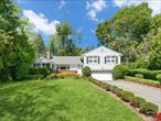 Beautifully tucked away on a quiet cul-de-sac, in a convenient, prime location on the border of New Rochelle, Eastchester and Scarsdale, this meticulous home will capture your heart from the moment you arrive. The peaceful setting, blooming flowers, exquisite bluestone masonry and magnificently manicured property set the tone that this is a special, well-cared-for home. Meaningful updates abound; all windows have been replaced, electric panel has been updated, central air condenser replaced, new hot water heater, new vinyl siding, new gutters, new exterior doors, new masonry and the list goes on. The spacious floor plan includes a large living room and formal dining room which expand to an inviting, sunfilled enclosed porch. Seamlessly blending indoor and outdoor living, the porch opens to both a large stone patio and an updated Trex deck. The eat-in kitchen showcases new Quartz counters and extensive cabinetry and opens to the spectacular, sprawling backyard. All of the bedrooms are sizable and all the bathrooms are pristine. The primary suite features multiple closets and an ensuite bathroom. With a private entrance, the lower level sets up nicely as a phenomenal family room and/or home office. Plus, the impressively clean basement presents 637 sq ft of bonus space, complete with laundry and endless storage. Bring your modern aesthetic, pull up the carpet, and make this fabulous haven your forever home. The 1971 sq ft of living space does not include the enclosed porch or the basement. All windows have been replaced. Meaningful updates include: New electric panel (2023), New air condenser (2022), New hot water heater (2019), New masonry (2012), New vinyl siding (2011), New gutters (2011), New exterior doors (2011), New Trex deck (2011), New Quartz countertops (2010), Alarm system (2022).