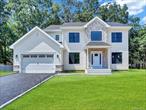 This is a rare opportunity to own new construction in Setauket, featuring a 2891 square foot custom Colonial set on a quiet cul de sac on a .75 acre lot. The exterior includes cedar style shake siding, white trim, partial stone facade, Andersen windows, a solar ready architectural roof, covered front portico, and a two car garage with opener and awning windows. Inside, the home offers a grand two story entry, hardwood floors, recessed lighting, custom moldings, and nine foot ceilings on the first floor. The open layout includes a chefs kitchen with stainless steel appliances, shaker cabinetry, quartz countertops, a center island with seating, pantry, mudroom, powder room, and access to the garage. The kitchen flows into a spacious great room with a gas fireplace, alongside a formal dining room and formal living room. Upstairs, the primary suite features a walk in closet and spa inspired bath with double sinks, while three additional bedrooms with large closets share a full hall bath with double sinks. The second floor also includes a laundry room with washer and dryer. Additional features are a full basement with eight foot ceilings, natural gas heat, two zone central air, and a 50 gallon hot water heater. Built by Kelly Development, an experienced Long Island builder with more than 30 years in the industry, the home comes with turnkey construction, pre move in cleaning, a new home orientation, and a comprehensive warranty. To be Built.