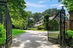 ROSLYN HARBOR; Timeless Brick Manor: Behind iron gates and a sweeping paver driveway, this 1926 Great Gatsbyâ€“era estate, sitting on 2.55 acres of lush, private grounds, combines classic elegance with modern luxury. Completely renovated in 2002, the residence offers nearly 10, 000 sq. ft. of living space, designed for both grand entertainment and everyday comfort. Featuring 6 bedrooms with 5.5 bathrooms, a dramatic foyer with floating staircase, banquet-sized dining room, formal living room with soaring windows, paneled study, a parlor/game room off of the kitchen, and a club-style custom-built speakeasy lounge/den with wet bar. The chefâ€™s kitchen, butlerâ€™s pantry, breakfast area, and multiple family spaces open to expansive brick and bluestone patios with pergolas. A primary suite with 2 levels features a gym loft, dual walk-in closets, a spa-like lavish bath with Jacuzzi and steam shower, elevator access, onyx fireplace, and balcony overlooking your resort-like grounds. Additional suites, a private cozy cinematic retreat with theatre and access to another grand office space, and a circular glass solarium (bathed in natural light with floor-to-ceiling glass walls and glass roof, offering year-round sunlight and a serene retreat to relax, read, and enjoy the outdoors from the comfort of indoors), complete the interior. Your private oasis and landscaped outdoor retreat feature an inground pool with waterfalls and grotto, pool house with bar and dining â€“ two BBQ areas, one off the kitchen and the other poolside, manicured lawns, and specimen plantings. A 3-car garage and ample courtyards provide exceptional parking. Located in Roslyn Harbor, just minutes from the train, golf, shopping, dining, and North Shore beaches â€” this secluded property offers a rare blend of privacy and convenience. Additional features include: access to 2 lower levels (with recreation rooms, walk in closets, utilities and storage), walk-up attic access with additional storage, high ceilings, 4 warm and inviting fireplaces (3 gas and 1 wood burning), radiant heated floors, a brand-new generator, central vacuum, two boilers with backup system, a full security and alarm system, and an elevator that transports you from level to level.