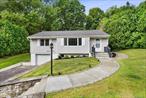 Come see this wonderful Ranch home in a prime Cortlandt location! Situated on over a third of an acre, this home offers a spacious and comfortable layout with 3 bedrooms and 2 full baths. The main level features an open floor plan, gleaming hardwood floors, and a well-kept kitchen complete with stainless steel appliances and quartz countertops. The finished basement includes a built-in bar, perfect for entertaining, while a new hot water heater adds peace of mind. Outside, youâ€™ll love the blue stone patio, a fully fenced backyard, and French drains around the back for excellent drainage and yard care. The attached garage with a large driveway provides plenty of parking. Step outside to enjoy the private outdoor spaceâ€”ideal for gatherings with family and friends. Conveniently located near Cortlandt Town Center, dining, shopping, Metro-North Railroad, and the Bear Mountain State Parkway, this home combines comfort with accessibility.